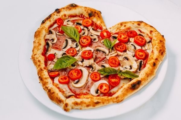 At-home date night Valentine's Day Ideas for couples: make or buy a heart pizza