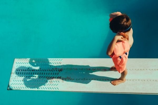 child standing at a diving board