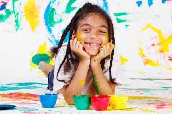 girl smiling with paint
