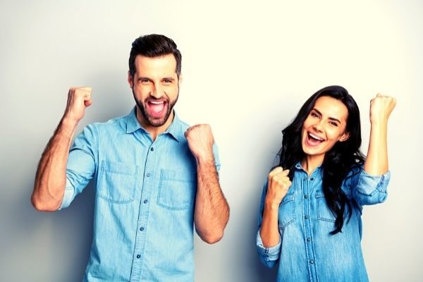 do 30 day challenges work? Man and woman pumping fists