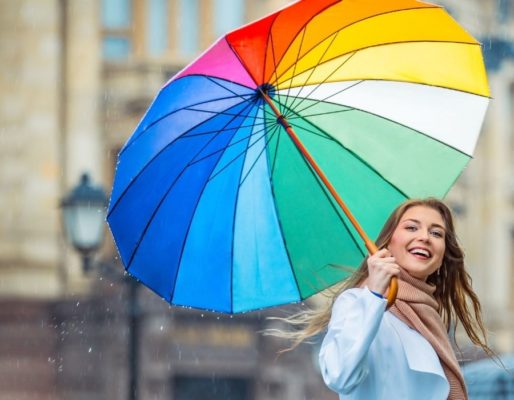 woman with umbrella doing one of the awesome 30 day happiness challenges