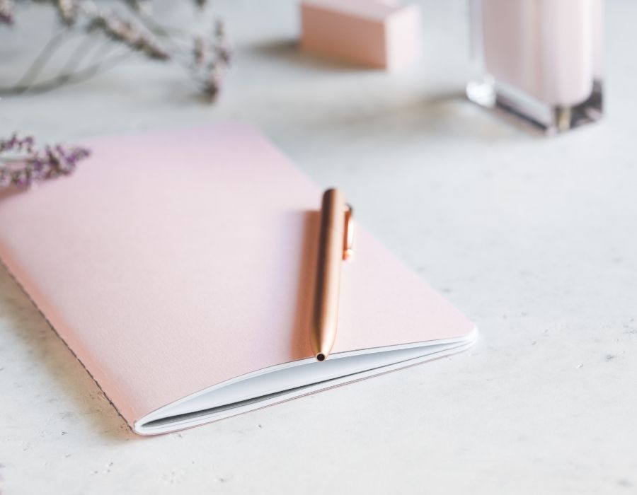 Journaling for self love with a pink journal and pen