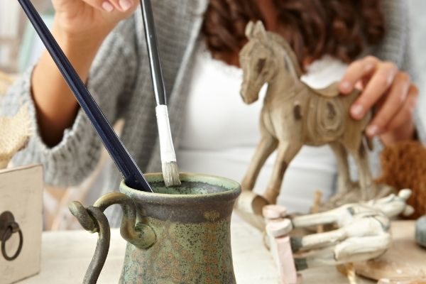 a woman painting a horse