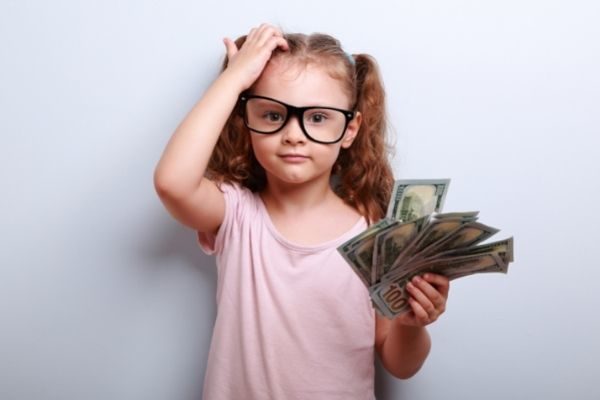 money makes for great conversation topics for kids: little girl with cash