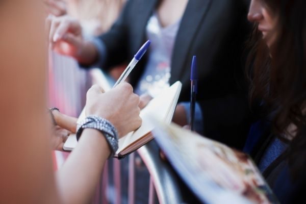 signing autographs