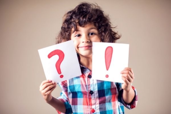 child holding up questions