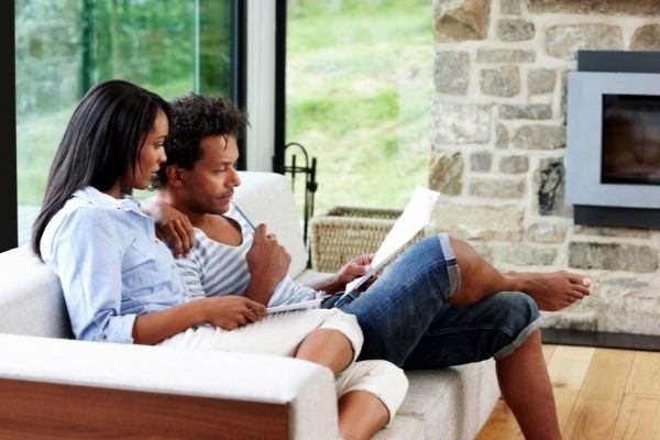 plan your future as one of your relationship goals: couple planning on the couch