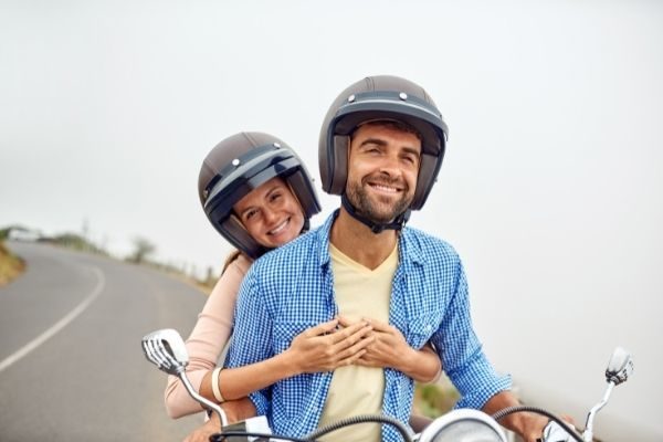 man and woman on a motorcycle