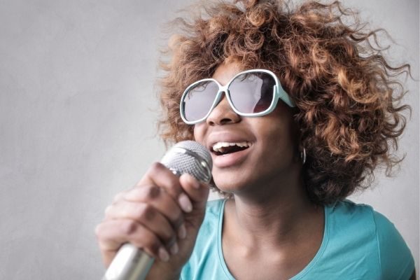 fun at home things to do for your birthday during covid or quarantine, woman singing