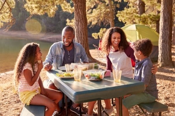 kids activities and things to do while camping, sitting around a table