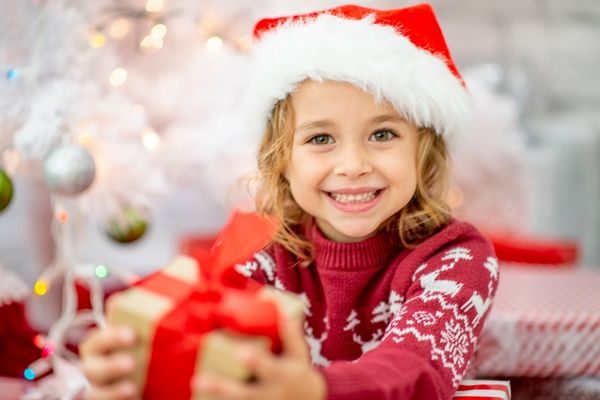 girl smiling holding a present