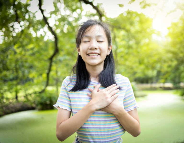 girl smiling: children deep breathing