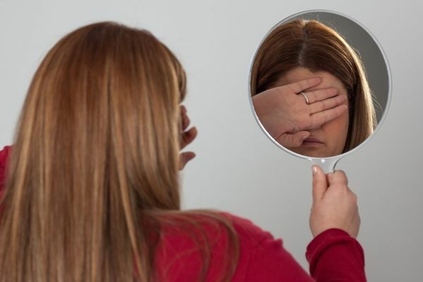 woman looking in the mirror