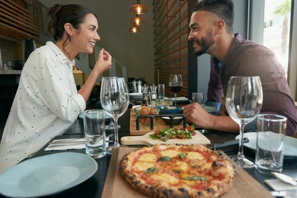 couple talking over food; date night questions for married couples