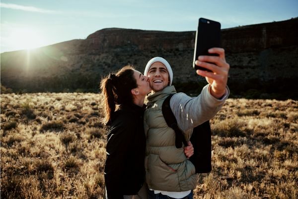 couple taking selfie; adventure date ideas