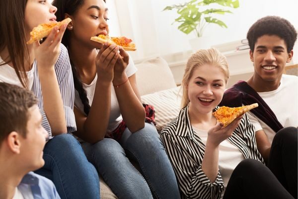 teenagers eating pizza; food and drink quiz questions and answers