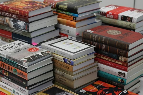 multiple stacks of books; literature trivia