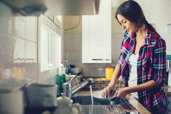 woman washing dishes; chore list