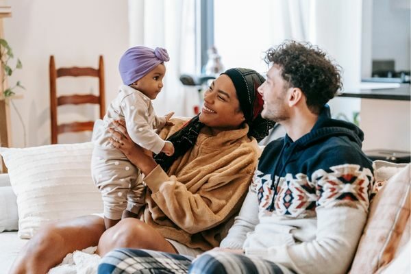 parents and child sitting on couch; topics for parents