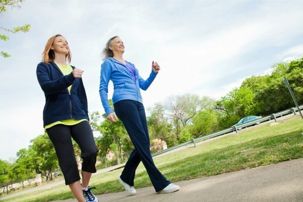 two women on a walk; symptoms and signs of mom burnout