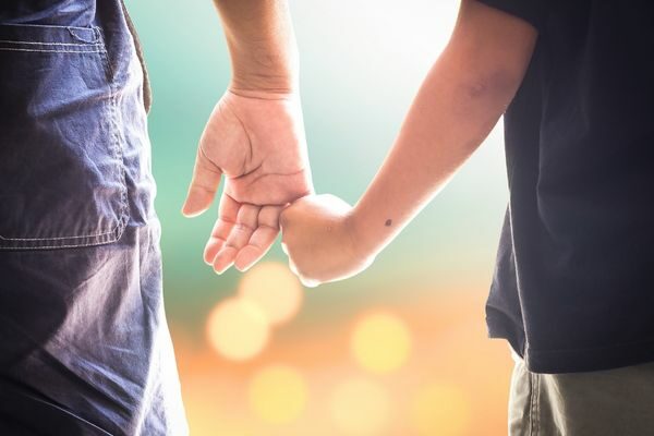 son and dad holding hands