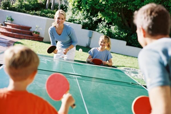 mom, dad, kids playing ping pong