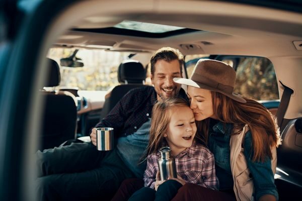 family laughing in the car