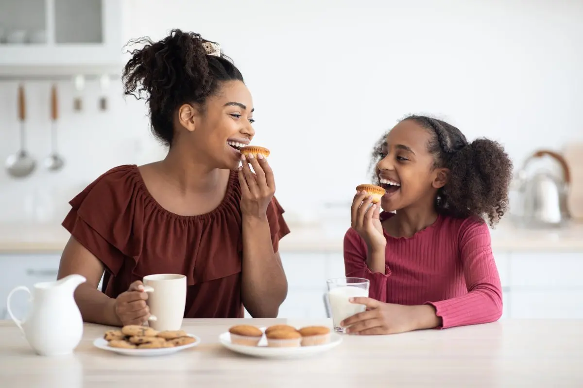 mom and daughter eating at a table