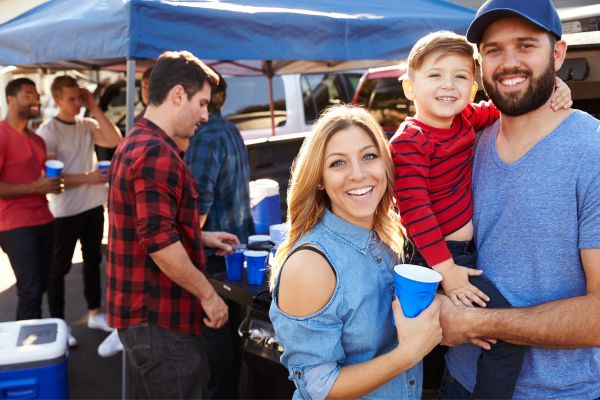 family of three at a tailgate; family events