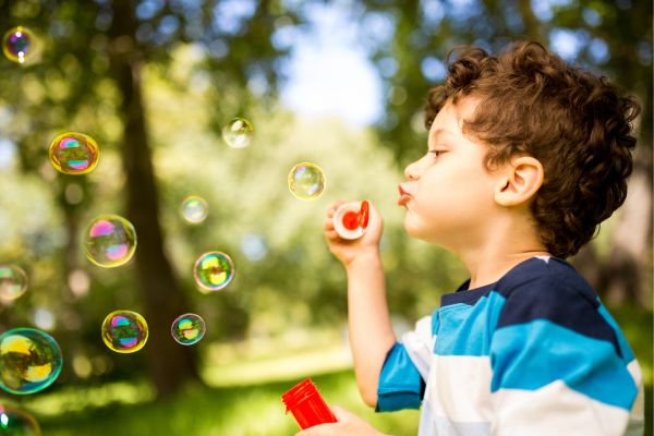 boy blowing bubbles: mom and son date night and day ideas, mum