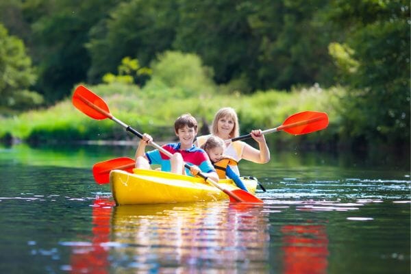 family paddling in the water