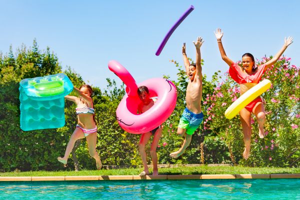 kids jumping into the pool