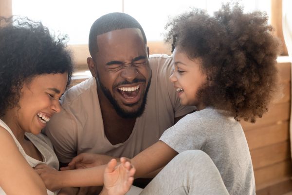 family of three laughing together