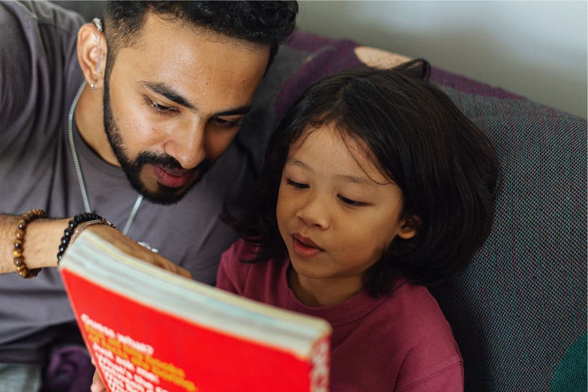 dad and daughter reading a book; pre reading strategies; post activities; during
