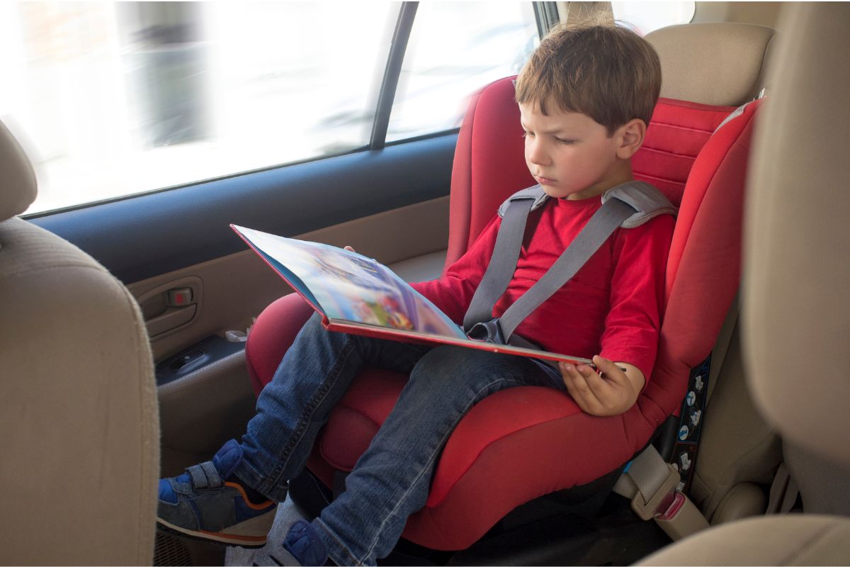 boy reading a book in the car
