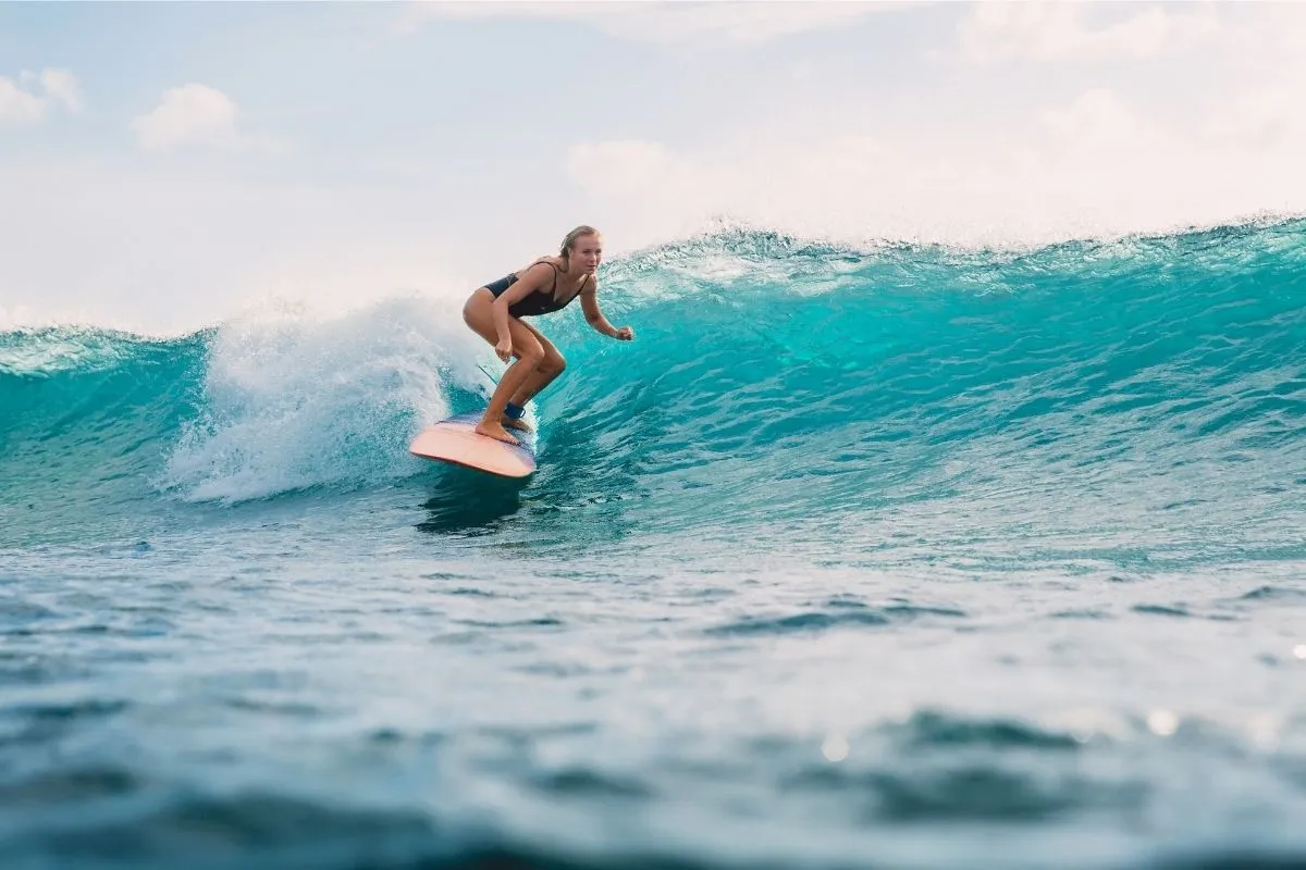 person surfing in the ocean; sports trivia