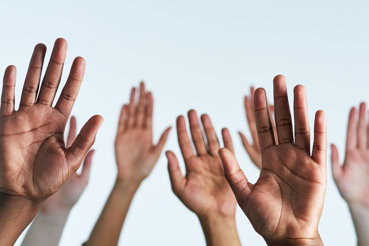 group of hands raised
