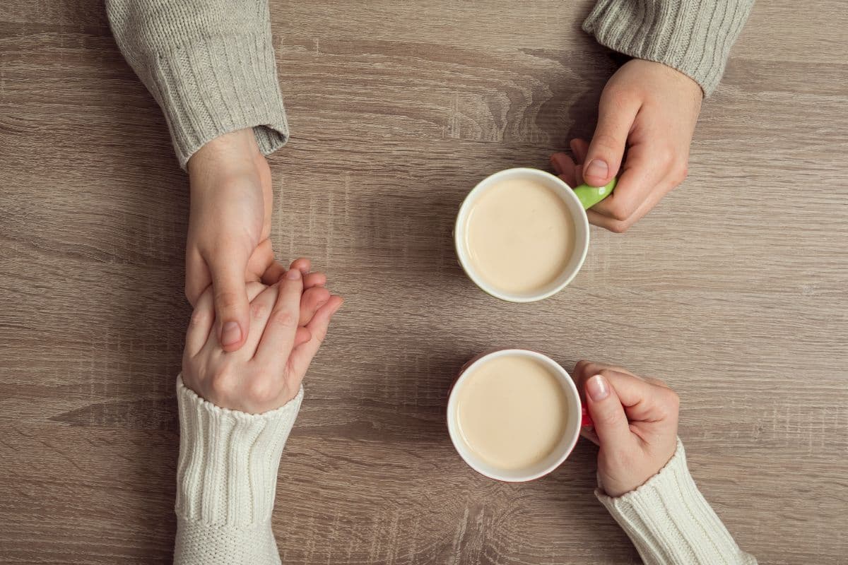hands holding and drinking coffee