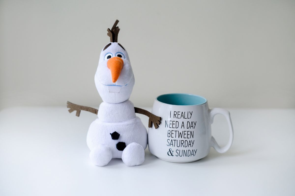 Olaf next to a mug