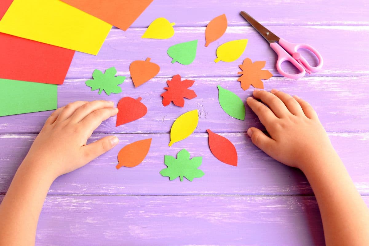 child cutting out leaves