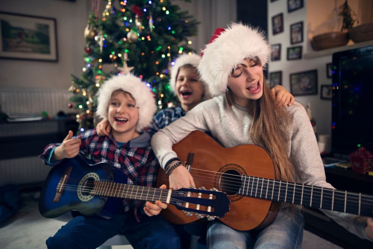family playing a guitar and singing