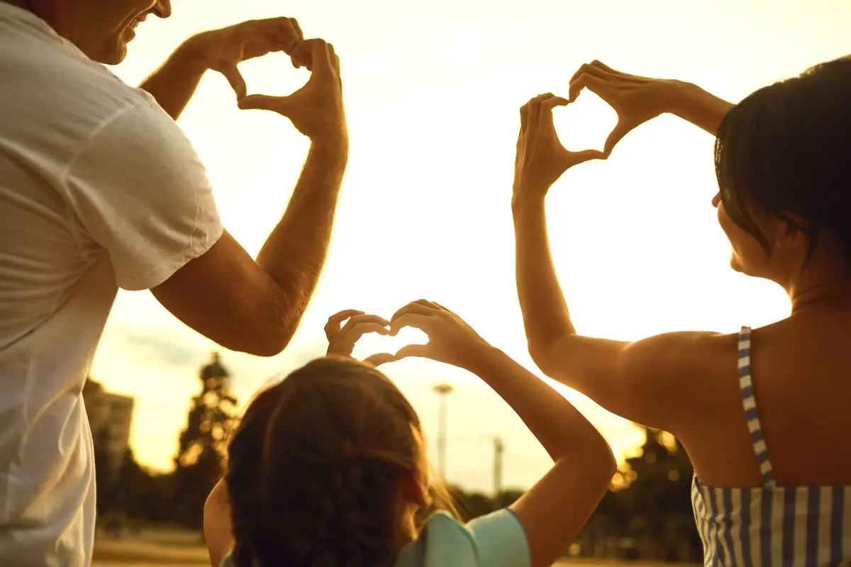 family with hearts in the air