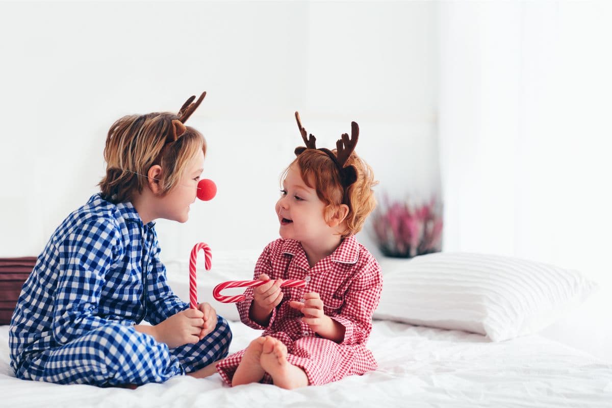 two kids wearing Rudolph antlers and red nose