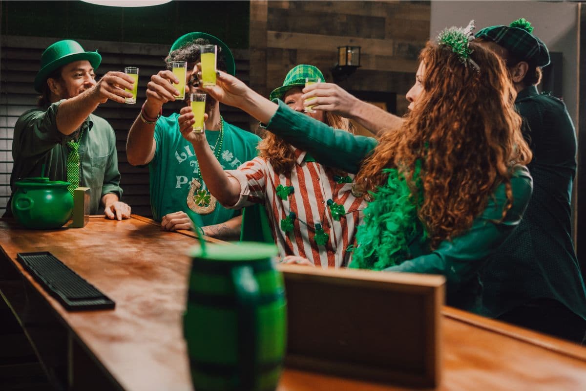 people celebrating at a bar in green