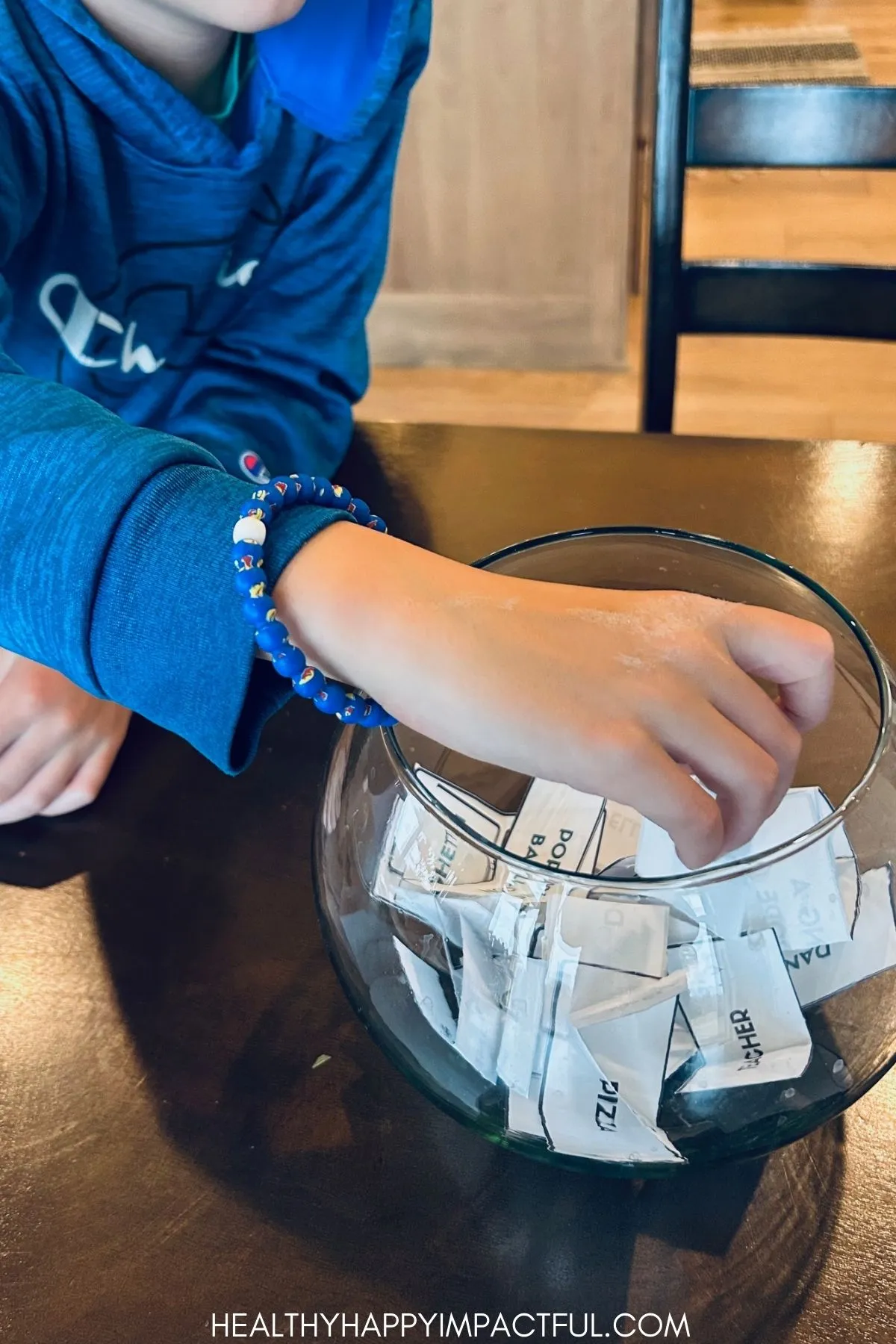 boy reaching in to pull out a word card