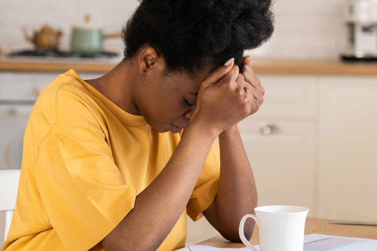 get help for your life, woman in the kitchen sitting with coffee