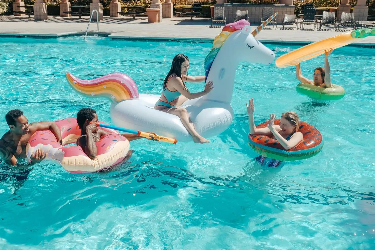 adults on inflatables; pool party games for adults
