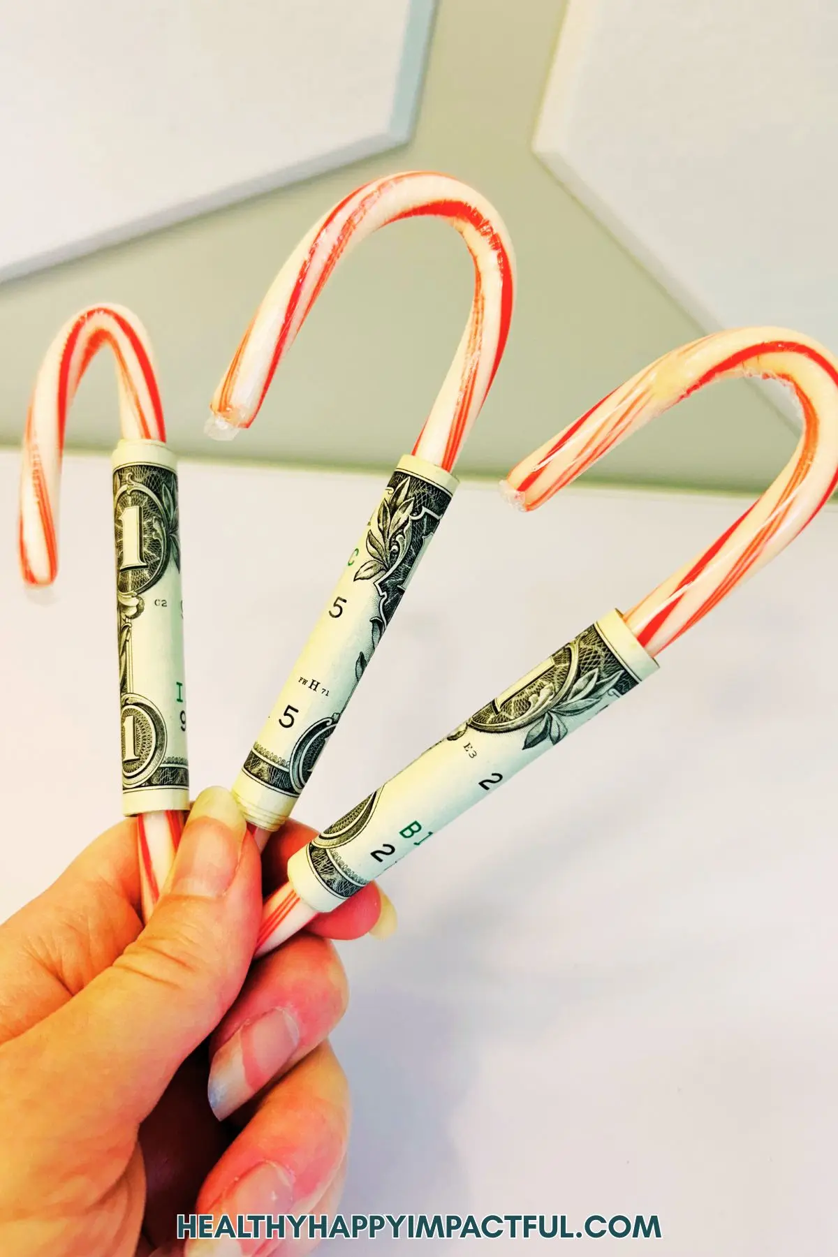 cash wrapped around candy canes