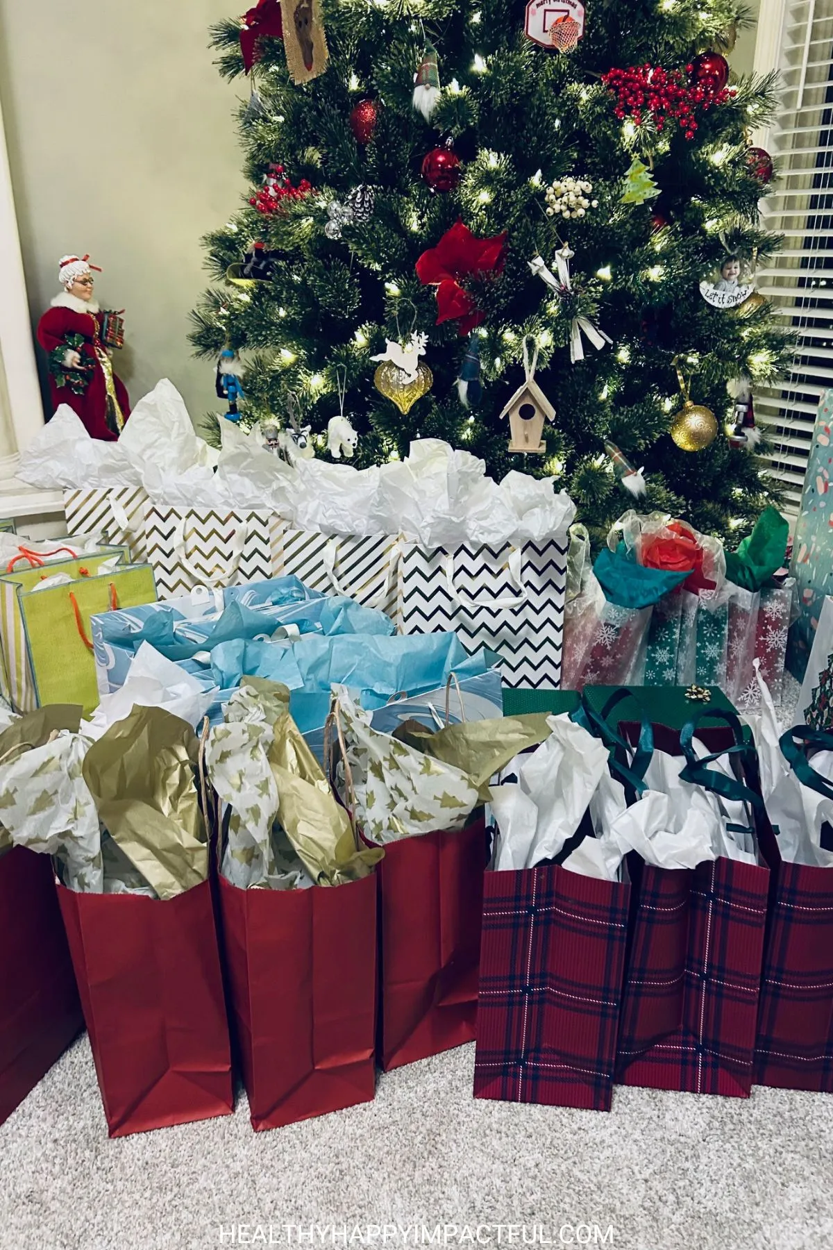 Christmas presents in front of a tree